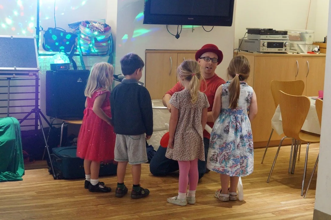 Benny talking with children during a real party