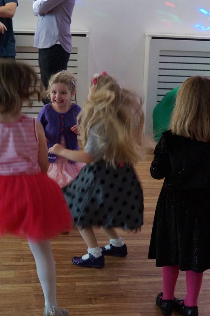 Children smiling and dancing at a real party