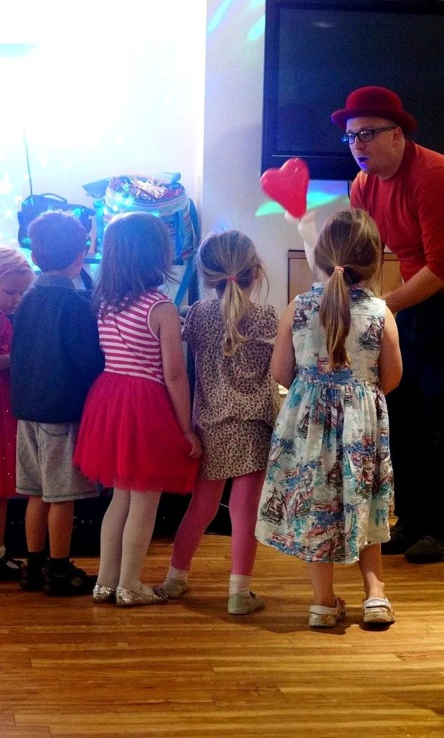 Benny Balloon making balloons for a group of children at a real party