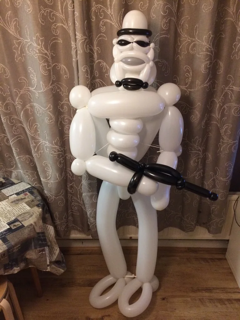 A full-height white and black sci-fi balloon character