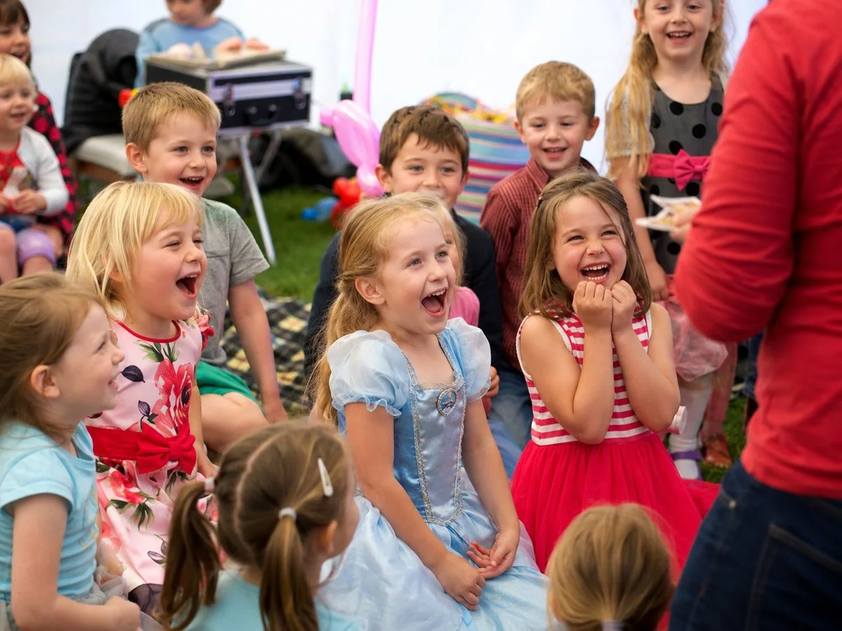 Children laughing and reacting during a Benny Balloon party